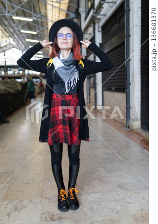 Young woman enjoying urban exploration in market hall Young woman enjoying urban exploration in market hall 136681370
