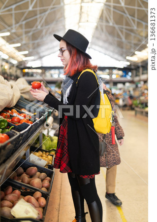 Young woman choosing fresh produce at local market Young woman choosing fresh produce at local market 136681373