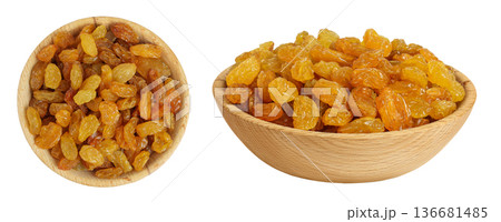 Yellow Raisins in wooden bowl isolated on white background. Top view. Flat lay, 136681485