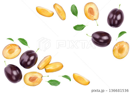 fresh purple plum and half with leaves isolated on white background with copy spase for your text. Top view. Flat lay fresh purple plum and half with leaves isolated on white background with copy spase for your text. Top view. Flat lay 136681536