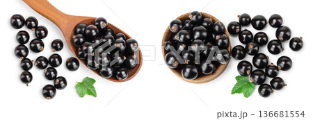 Black currants in wooden spoon and bowl on white background.Top view. Flat lay pattern Black currants in wooden spoon and bowl on white background.Top view. Flat lay pattern 136681554