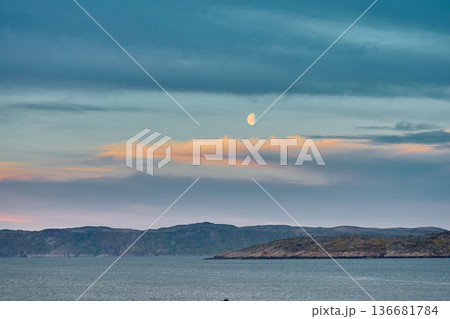 Weathered wooden houses in Teriberka at dusk, Russia, Kola Peninsula, evoke a bygone era, standing as silent witnesses to the passage of time. Teriberka's historical architecture concept Weathered wooden houses in Teriberka at dusk, Russia, Kola Peninsula, evoke a bygone era, standing as silent witnesses to the passage of time. Teriberka's historical architecture concept 136681784