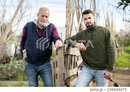 Elderly and young man in garden Elderly and young man in garden 136684875