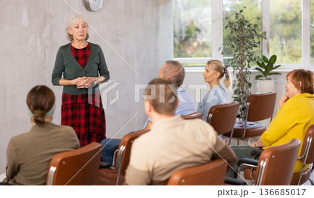 Elderly female tutor teaching group of mature students Elderly female tutor teaching group of mature students 136685017