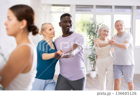 African American man dancing slow dance with aged woman African American man dancing slow dance with aged woman 136685126