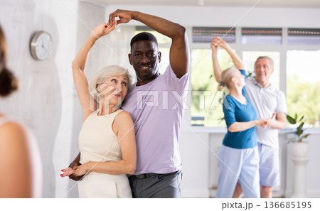Group of multiethnic mature people dancing social dance Group of multiethnic mature people dancing social dance 136685195