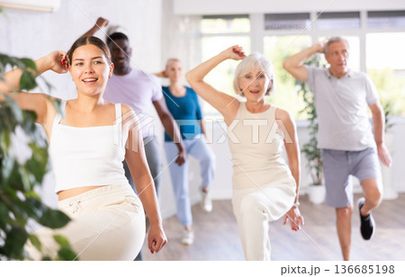 Young woman teaching hip hop to group of multiethnic mature people Young woman teaching hip hop to group of multiethnic mature people 136685198