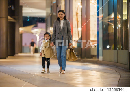 mother and little child girl walking with shopping bag and sightseeing in Bangkok city at night mother and little child girl walking with shopping bag and sightseeing in Bangkok city at night 136685444