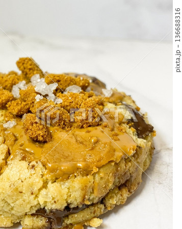 Freshly baked cookies with a golden-brown finish and chocolate chips. Perfectly crisp on the edges with a soft center, offering a delicious, comforting treat for any occasion. 136688316