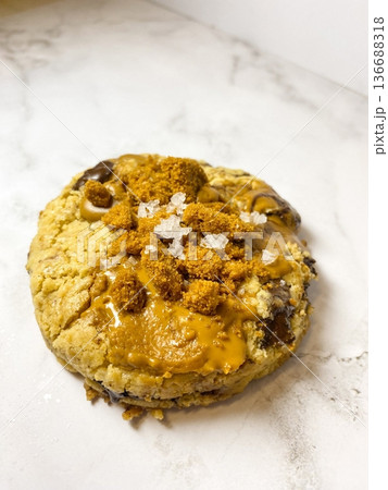 Freshly baked cookies with a golden-brown finish and chocolate chips. Perfectly crisp on the edges with a soft center, offering a delicious, comforting treat for any occasion. 136688318