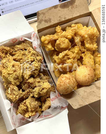 Crispy Korean fried chicken, perfectly glazed with a sweet and spicy sauce. Ideal for food photography and menus, showcasing the irresistible crunch and flavor of this beloved dish. 136688591