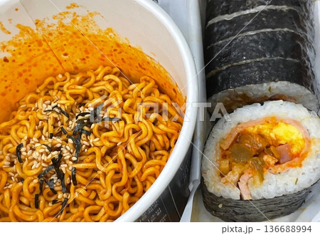 Kimbap and Ramyun, a perfect Korean combo! Enjoy savory rice rolls with vegetables, meat, and pickles alongside a flavorful bowl of spicy, comforting ramen. A satisfying meal for any time of day. Kimbap and Ramyun, a perfect Korean combo! Enjoy savory rice rolls with vegetables, meat, and pickles alongside a flavorful bowl of spicy, comforting ramen. A satisfying meal for any time of day. 136688994