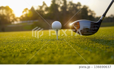 Golf clubs and balls on a green lawn in a beautiful golf course with morning sunshine. 136690637