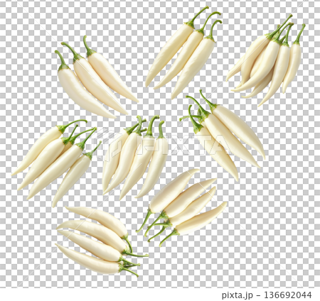 Fresh white chili peppers with green stems arranged in groups, isolated on a white background. Concept of spicy food 136692044
