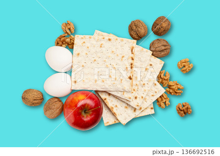 Matzah, eggs, nuts, and an apple are arranged together 136692516