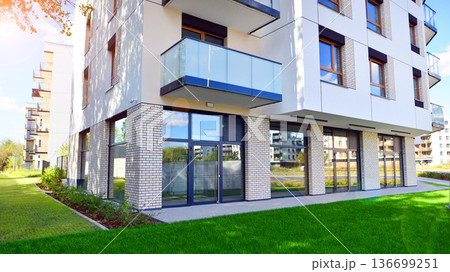 The garden of a modern residential building with a green lawn and a place to relax. The garden of a modern residential building with a green lawn and a place to relax. 136699251