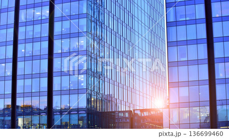 Modern sustainable glass office buildings. Exterior view of corporate headquarters glass buildings architecture.Glass windows in energy-efficient buildings. Financial business center buildings.  136699460