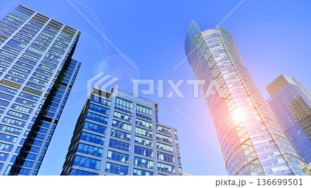 Modern sustainable glass office buildings. Exterior view of corporate headquarters glass buildings architecture.Glass windows in energy-efficient buildings. Financial business center buildings.  136699501