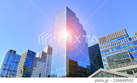 Modern sustainable glass office buildings. Exterior view of corporate headquarters glass buildings architecture.Glass windows in energy-efficient buildings. Financial business center buildings.  136699502