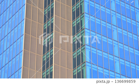 Modern sustainable glass office buildings. Exterior view of corporate headquarters glass buildings architecture.Glass windows in energy-efficient buildings. Financial business center buildings. Modern sustainable glass office buildings. Exterior view of corporate headquarters glass buildings architecture.Glass windows in energy-efficient buildings. Financial business center buildings. 136699859