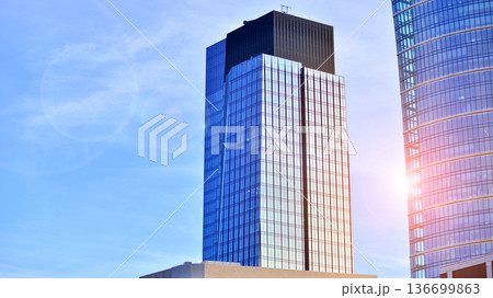 Modern sustainable glass office buildings. Exterior view of corporate headquarters glass buildings architecture.Glass windows in energy-efficient buildings. Financial business center buildings. Modern sustainable glass office buildings. Exterior view of corporate headquarters glass buildings architecture.Glass windows in energy-efficient buildings. Financial business center buildings. 136699863