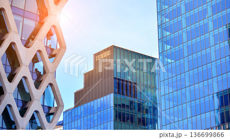 Modern sustainable glass office buildings. Exterior view of corporate headquarters glass buildings architecture.Glass windows in energy-efficient buildings. Financial business center buildings. Modern sustainable glass office buildings. Exterior view of corporate headquarters glass buildings architecture.Glass windows in energy-efficient buildings. Financial business center buildings. 136699866