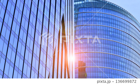 Modern sustainable glass office buildings. Exterior view of corporate headquarters glass buildings architecture.Glass windows in energy-efficient buildings. Financial business center buildings.  136699872