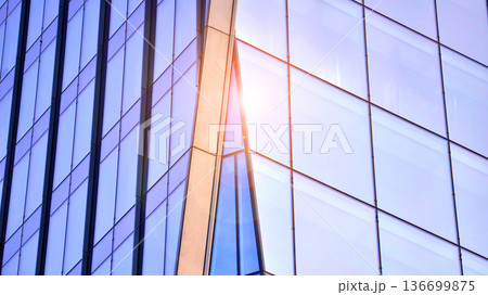 Modern sustainable glass office buildings. Exterior view of corporate headquarters glass buildings architecture.Glass windows in energy-efficient buildings. Financial business center buildings. Modern sustainable glass office buildings. Exterior view of corporate headquarters glass buildings architecture.Glass windows in energy-efficient buildings. Financial business center buildings. 136699875