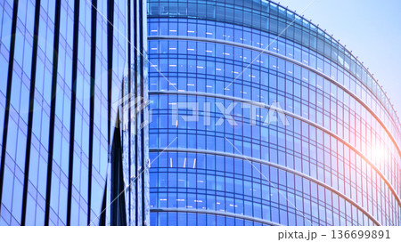 Modern sustainable glass office buildings. Exterior view of corporate headquarters glass buildings architecture.Glass windows in energy-efficient buildings. Financial business center buildings. Modern sustainable glass office buildings. Exterior view of corporate headquarters glass buildings architecture.Glass windows in energy-efficient buildings. Financial business center buildings. 136699891