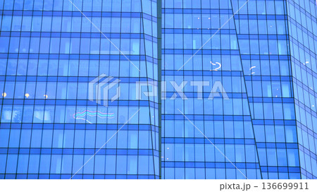Modern sustainable glass office buildings. Exterior view of corporate headquarters glass buildings architecture.Glass windows in energy-efficient buildings. Financial business center buildings. Modern sustainable glass office buildings. Exterior view of corporate headquarters glass buildings architecture.Glass windows in energy-efficient buildings. Financial business center buildings. 136699911