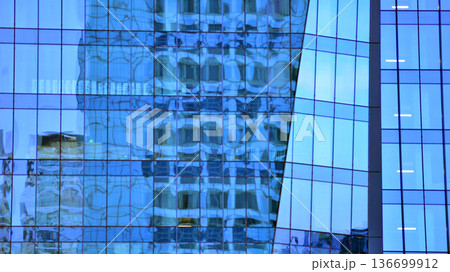 Modern sustainable glass office buildings. Exterior view of corporate headquarters glass buildings architecture.Glass windows in energy-efficient buildings. Financial business center buildings.  136699912