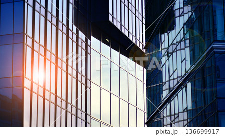Modern sustainable glass office buildings. Exterior view of corporate headquarters glass buildings architecture.Glass windows in energy-efficient buildings. Financial business center buildings. Modern sustainable glass office buildings. Exterior view of corporate headquarters glass buildings architecture.Glass windows in energy-efficient buildings. Financial business center buildings. 136699917