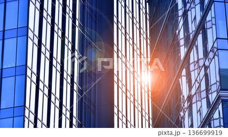 Modern sustainable glass office buildings. Exterior view of corporate headquarters glass buildings architecture.Glass windows in energy-efficient buildings. Financial business center buildings.  136699919