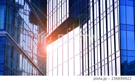 Modern sustainable glass office buildings. Exterior view of corporate headquarters glass buildings architecture.Glass windows in energy-efficient buildings. Financial business center buildings. Modern sustainable glass office buildings. Exterior view of corporate headquarters glass buildings architecture.Glass windows in energy-efficient buildings. Financial business center buildings. 136699922