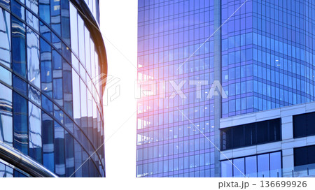 Modern sustainable glass office buildings. Exterior view of corporate headquarters glass buildings architecture.Glass windows in energy-efficient buildings. Financial business center buildings.  136699926