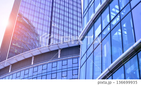 Modern sustainable glass office buildings. Exterior view of corporate headquarters glass buildings architecture.Glass windows in energy-efficient buildings. Financial business center buildings. Modern sustainable glass office buildings. Exterior view of corporate headquarters glass buildings architecture.Glass windows in energy-efficient buildings. Financial business center buildings. 136699935