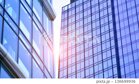 Modern sustainable glass office buildings. Exterior view of corporate headquarters glass buildings architecture.Glass windows in energy-efficient buildings. Financial business center buildings.  136699936