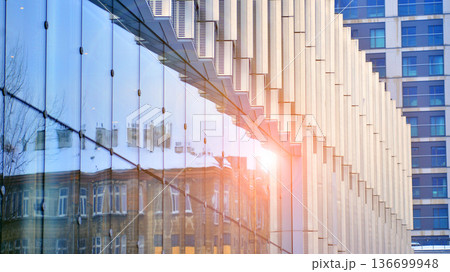 Modern sustainable glass office buildings. Exterior view of corporate headquarters glass buildings architecture.Glass windows in energy-efficient buildings. Financial business center buildings. Modern sustainable glass office buildings. Exterior view of corporate headquarters glass buildings architecture.Glass windows in energy-efficient buildings. Financial business center buildings. 136699948