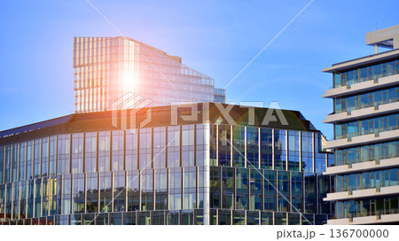 Exterior view of corporate headquarters glass buildings architecture. Modern sustainable glass office buildings. Glass windows in energy-efficient buildings. Financial business center buildings.  136700000