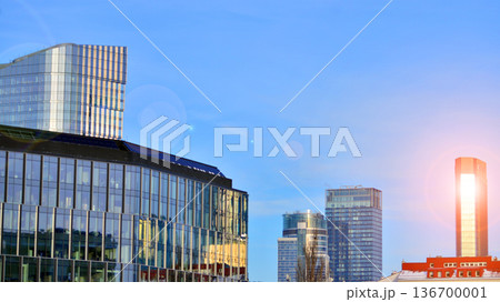 Exterior view of corporate headquarters glass buildings architecture. Modern sustainable glass office buildings. Glass windows in energy-efficient buildings. Financial business center buildings. Exterior view of corporate headquarters glass buildings architecture. Modern sustainable glass office buildings. Glass windows in energy-efficient buildings. Financial business center buildings. 136700001