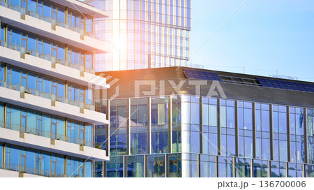 Exterior view of corporate headquarters glass buildings architecture. Modern sustainable glass office buildings. Glass windows in energy-efficient buildings. Financial business center buildings. Exterior view of corporate headquarters glass buildings architecture. Modern sustainable glass office buildings. Glass windows in energy-efficient buildings. Financial business center buildings. 136700006