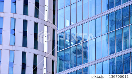 Exterior view of corporate headquarters glass buildings architecture. Modern sustainable glass office buildings. Glass windows in energy-efficient buildings. Financial business center buildings. Exterior view of corporate headquarters glass buildings architecture. Modern sustainable glass office buildings. Glass windows in energy-efficient buildings. Financial business center buildings. 136700011