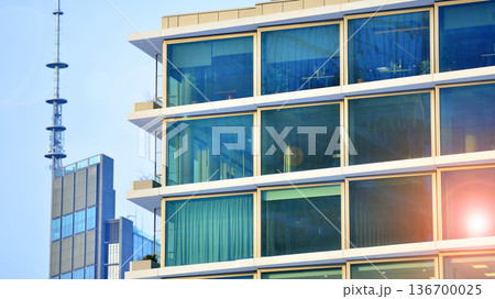 Exterior view of corporate headquarters glass buildings architecture. Modern sustainable glass office buildings. Glass windows in energy-efficient buildings. Financial business center buildings. Exterior view of corporate headquarters glass buildings architecture. Modern sustainable glass office buildings. Glass windows in energy-efficient buildings. Financial business center buildings. 136700025