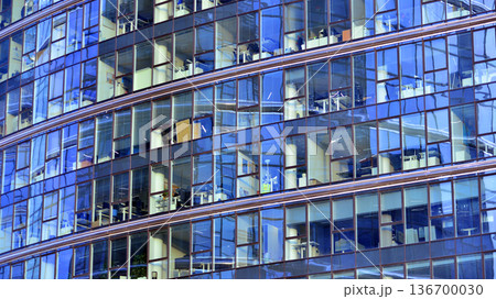 Exterior view of corporate headquarters glass buildings architecture. Modern sustainable glass office buildings. Glass windows in energy-efficient buildings. Financial business center buildings.  136700030