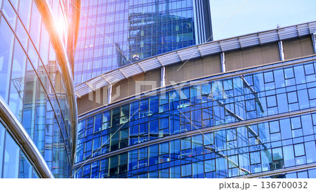 Exterior view of corporate headquarters glass buildings architecture. Modern sustainable glass office buildings. Glass windows in energy-efficient buildings. Financial business center buildings. Exterior view of corporate headquarters glass buildings architecture. Modern sustainable glass office buildings. Glass windows in energy-efficient buildings. Financial business center buildings. 136700032