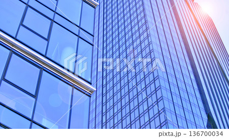 Exterior view of corporate headquarters glass buildings architecture. Modern sustainable glass office buildings. Glass windows in energy-efficient buildings. Financial business center buildings.  136700034
