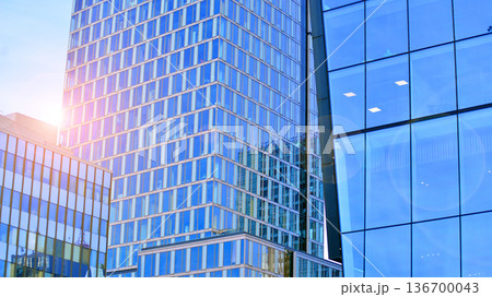 Exterior view of corporate headquarters glass buildings architecture. Modern sustainable glass office buildings. Glass windows in energy-efficient buildings. Financial business center buildings. Exterior view of corporate headquarters glass buildings architecture. Modern sustainable glass office buildings. Glass windows in energy-efficient buildings. Financial business center buildings. 136700043