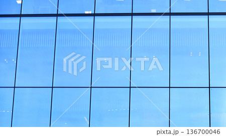 Exterior view of corporate headquarters glass buildings architecture. Modern sustainable glass office buildings. Glass windows in energy-efficient buildings. Financial business center buildings.  136700046