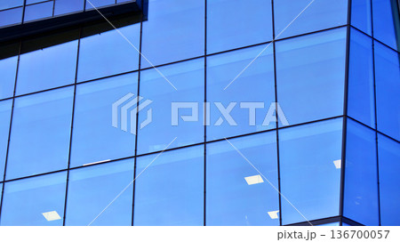 Exterior view of corporate headquarters glass buildings architecture. Modern sustainable glass office buildings. Glass windows in energy-efficient buildings. Financial business center buildings. Exterior view of corporate headquarters glass buildings architecture. Modern sustainable glass office buildings. Glass windows in energy-efficient buildings. Financial business center buildings. 136700057