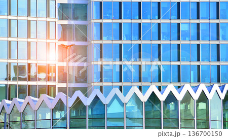 Exterior view of corporate headquarters glass buildings architecture. Modern sustainable glass office buildings. Glass windows in energy-efficient buildings. Financial business center buildings. Exterior view of corporate headquarters glass buildings architecture. Modern sustainable glass office buildings. Glass windows in energy-efficient buildings. Financial business center buildings. 136700150